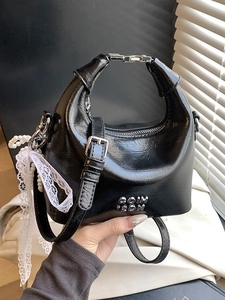 Chic black glossy handbag with pearl lace pendant and metallic logo handle strap