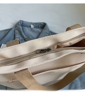Top view detail of high-density canvas tote featuring smooth zipper and inner pocket