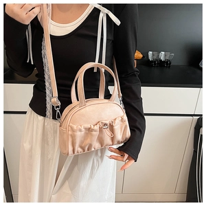Fashionable pink mini crossbody bag with drawstring ruched pocket detail and top handle