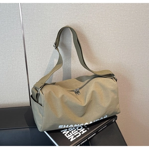 Detail of olive green canvas pillow bag with metal double zipper and adjustable strap