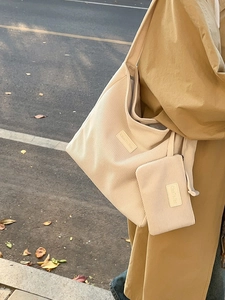 Large beige corduroy tote bag and matching pouch set for women in outdoor street setting