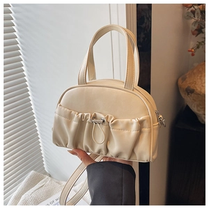 Detailed close-up of cream PU leather handbag featuring stylish ruched drawstring pocket