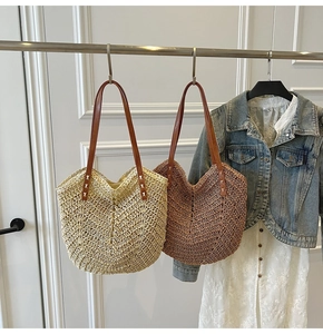 Detail of hand-woven straw tote bag with V-shaped texture and leather shoulder straps