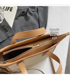 Close-up of smooth gold metal zipper on straw and leather bucket bag with Life magazine