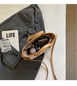 Top view of spacious canvas basket bag interior with phone and perfume items