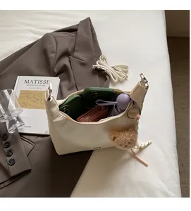 Interior view of off-white leather crescent bag showing large capacity for essentials