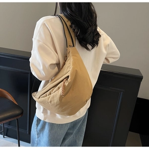 Khaki crescent dumpling bag with wide shoulder strap and woven zipper detail