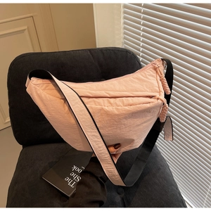 Detailed macro view of pink nylon dumpling bag texture and premium zipper puller