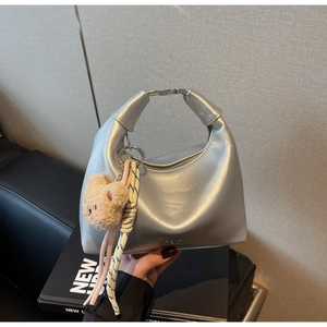 Silver metallic crescent hobo bag featuring a cute plush bear charm and woven cord detail