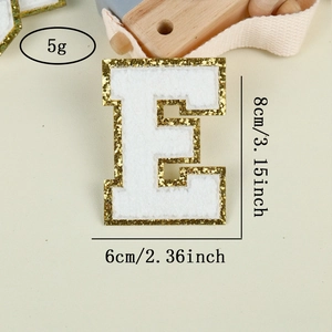 Detail of white chenille letter E patch with gold glitter edge and 8cm dimensions