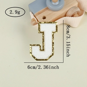Macro shot of letter J towel embroidery patch with gold sequins and 8cm height dimension