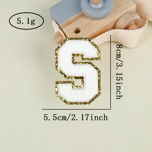 Detail view of Varsity letter S patch with white chenille fabric and gold sequins