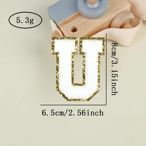 Macro shot of letter U chenille patch with gold sequins and 8cm size dimensions