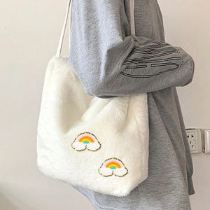 Model wearing a white faux fur tote bag featuring colorful rainbow embroidery patches