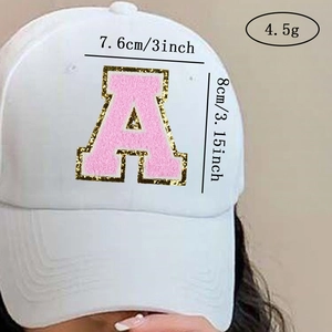 Detailed view of pink chenille letter A patch with gold glitter on a white baseball cap
