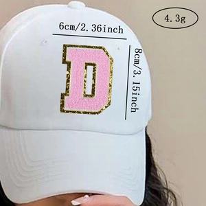 Detail of pink chenille letter D patch with gold sequins on a white baseball cap