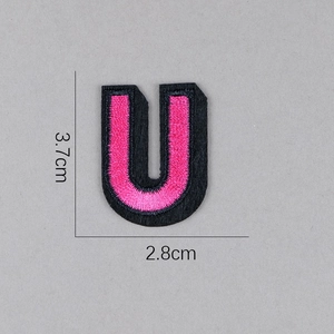 Vue détaillée de l'écusson brodé lettre U rose avec bord noir, taille 3,7 x 2,8 cm
