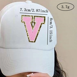 Detail of pink chenille letter V patch with gold glitter on a white baseball cap