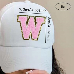 Detail of pink chenille letter W patch with gold sequins on white baseball cap