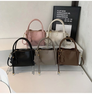 Detail of five stylish crossbody bags in various colors with cute bear pendants