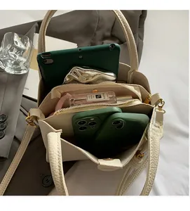 Interior view showing three-layer storage layout of beige pebbled leather bucket bag