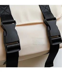 Close-up of durable nylon messenger bag showing secure plastic buckles and fine texture