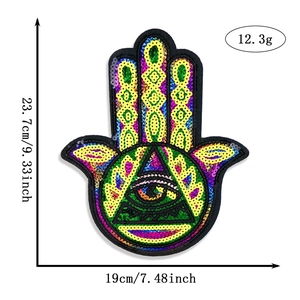 Macro view of Hamsa hand sequin patch with dimensions 23.7x19cm for DIY apparel