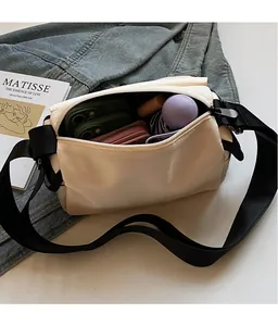 Top view of cream messenger bag showing spacious interior for daily essentials