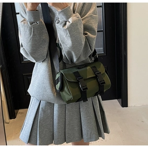 Detail view of military green waterproof nylon messenger bag with black buckles
