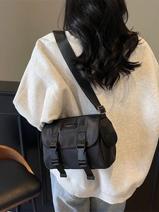 Retro black nylon messenger bag with double buckle flap for women in street style fashion