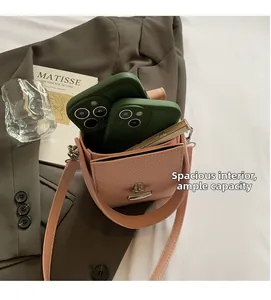 Interior view showing the capacity of a pink textured crossbody bag with two smartphones