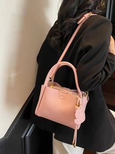 Pink lychee grain bucket bag with cute bear charm and adjustable shoulder strap for women