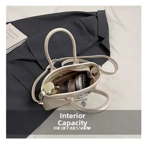 Detail view of beige crossbody bag showing spacious interior for phone and cosmetics