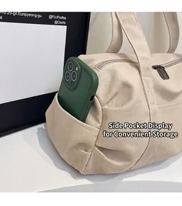 Detailed view of canvas duffel bag side pocket holding a smartphone for storage