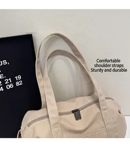 Close-up of sturdy canvas tote bag with reinforced handles and dual metal zippers