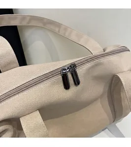 Detail view of durable canvas travel bag featuring smooth dual metal zipper hardware
