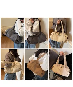 Detail view of large canvas travel duffel bags in earth tones with adjustable straps