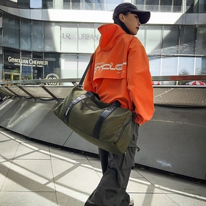 Vue de rue extérieure d'un grand sac de fitness vert olive avec sangle NOCO