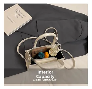Interior view showing the capacity of the white crossbody bag for daily essentials