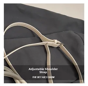 Detailed macro view of adjustable cream faux leather shoulder strap with silver buckle