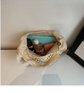 Top view showing a spacious straw bag interior with lace trim holding daily essentials