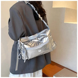 Silver metallic padded nylon crossbody bag with zipper pockets and teddy bear detail