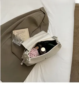 Top view of cream white chain bag showing large capacity interior with daily essentials