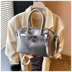Close-up of metallic silver handbag with iconic metal padlock and buckle details