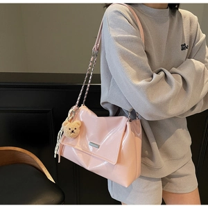 Pink patent leather tote with metal chain strap, teddy charm and striped scarf detail