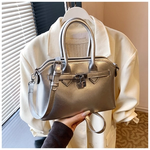 Close-up of metallic silver handbag featuring metal buckle and premium textured finish