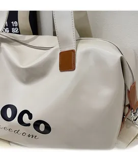 Macro shot of cream travel bag with PU leather texture and OCO freedom lettering