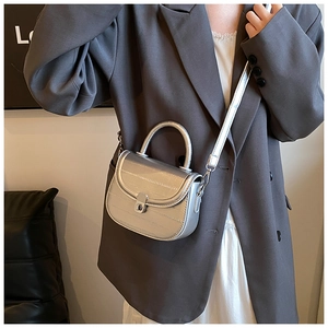 Silver crocodile texture mini saddle bag shown on model for style and size reference