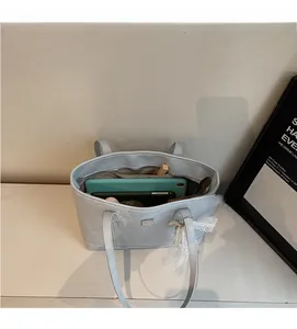 Top-down view of spacious blue ostrich textured tote bag showing interior storage capacity