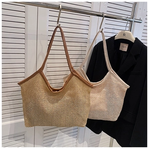 Detail of woven straw tote bag with leather straps for summer beach vacation styling
